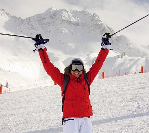 Snowboarder performing a trick against a snowy Mt. Buller backdrop.
